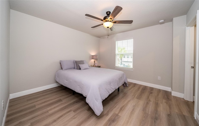 26082 Woven Wicker Bnd, Lutz, FL 33559 - bedroom with light wood-style flooring and ceiling fan