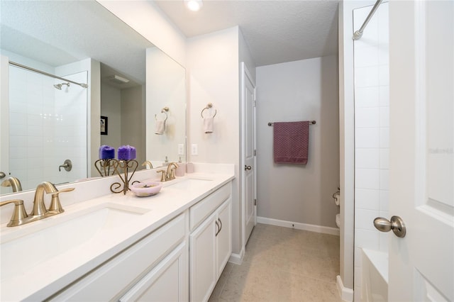 26082 Woven Wicker Bnd, Lutz, FL 33559 - bathroom featuring double vanity, a shower, tile patterned flooring, and a textured ceiling