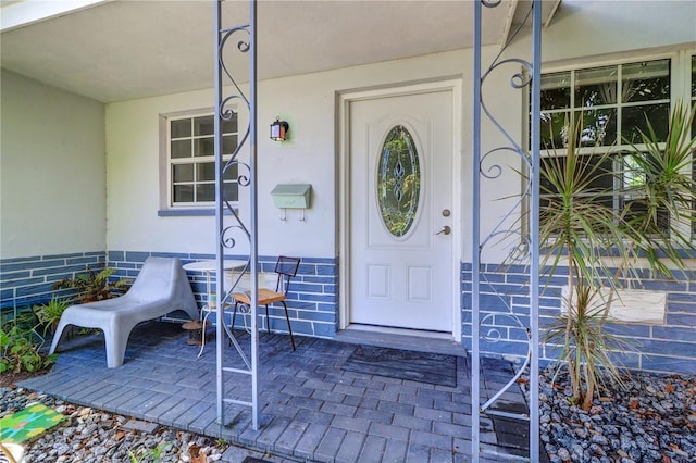 3910 14th Ave N, Saint Petersburg, FL 33713 - property entrance featuring covered porch and stucco siding