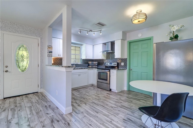 3910 14th Ave N, Saint Petersburg, FL 33713 - kitchen featuring appliances with stainless steel finishes, wall chimney exhaust hood, and white cabinets