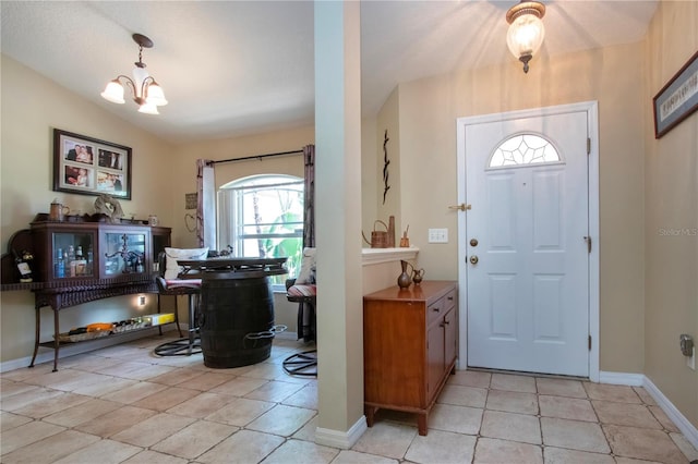 408 River Bed Ct, Wimauma, FL 33598 - entryway with healthy amount of natural light, a chandelier, and light tile patterned flooring