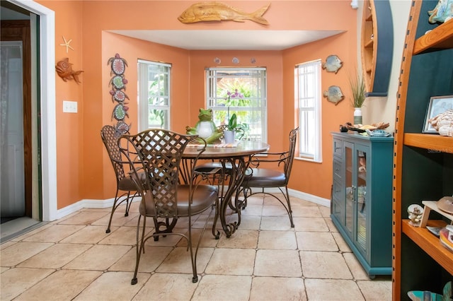408 River Bed Ct, Wimauma, FL 33598 - dining area featuring healthy amount of natural light and light tile patterned floors