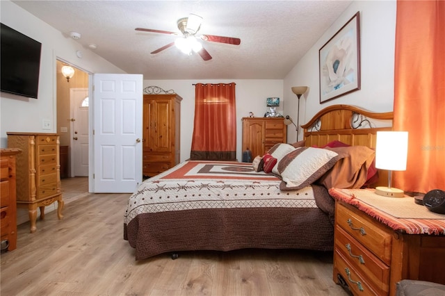 408 River Bed Ct, Wimauma, FL 33598 - bedroom with light wood-type flooring, a textured ceiling, and ceiling fan