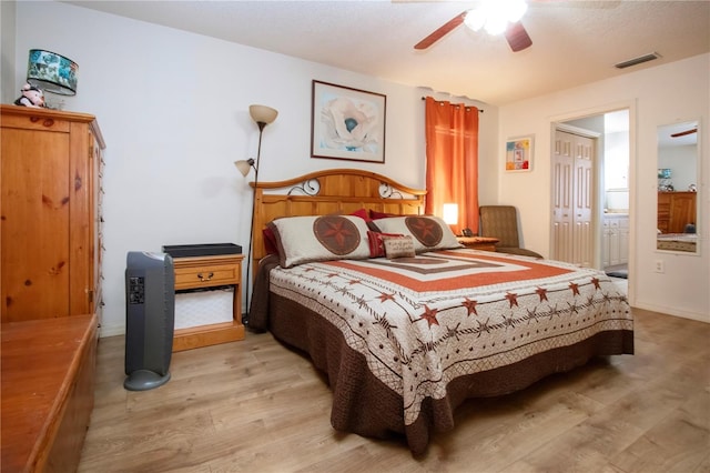 408 River Bed Ct, Wimauma, FL 33598 - bedroom featuring light wood finished floors, ensuite bath, and ceiling fan