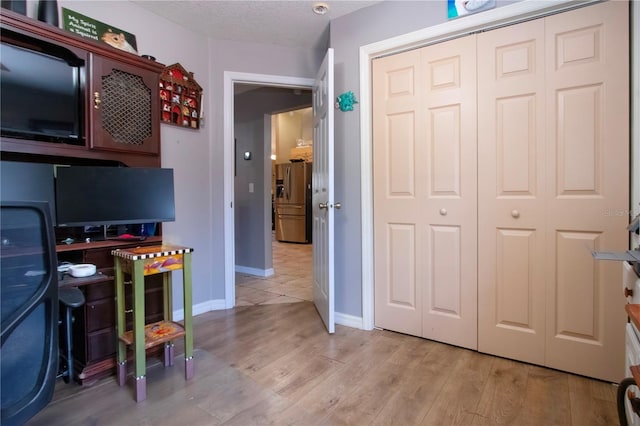 408 River Bed Ct, Wimauma, FL 33598 - home office featuring light wood-style flooring and a textured ceiling