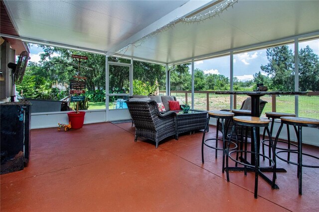 408 River Bed Ct, Wimauma, FL 33598 - sunroom with an outdoor hangout area