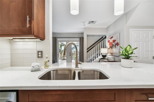 344 Cascade Ln, Palm Harbor, FL 34684 - kitchen with backsplash, brown cabinets, and light stone countertops