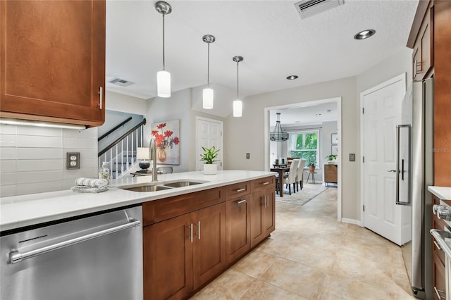 344 Cascade Ln, Palm Harbor, FL 34684 - kitchen featuring stainless steel dishwasher, light countertops, hanging light fixtures, range, and brown cabinets