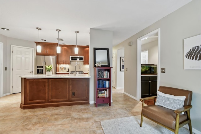 344 Cascade Ln, Palm Harbor, FL 34684 - kitchen with stainless steel appliances, light countertops, backsplash, hanging light fixtures, and brown cabinets