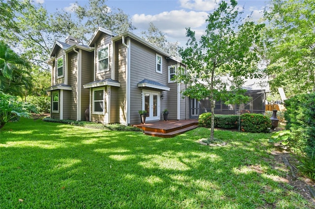 344 Cascade Ln, Palm Harbor, FL 34684 - rear view of house featuring a deck, a lawn, and french doors