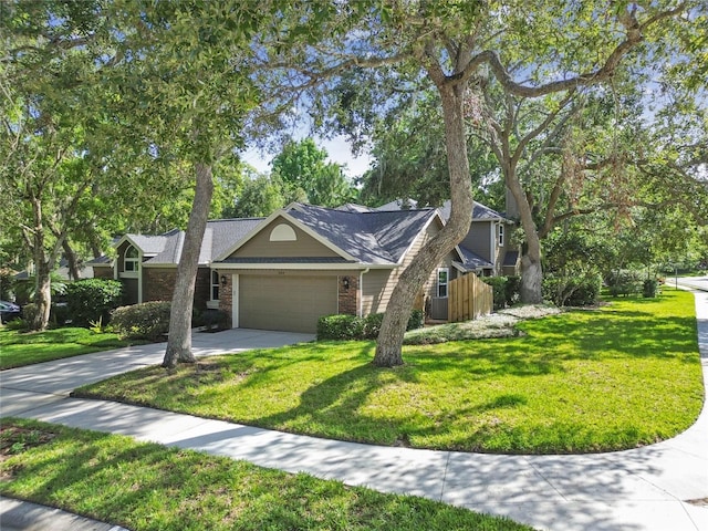 344 Cascade Ln, Palm Harbor, FL 34684 - obstructed view of property with a garage, driveway, a front lawn, and brick siding