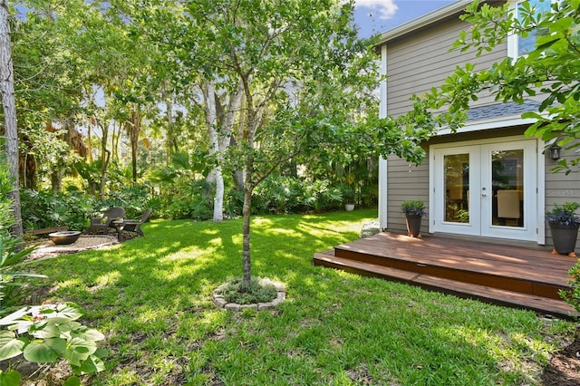 344 Cascade Ln, Palm Harbor, FL 34684 - view of grassy yard with french doors and a wooden deck