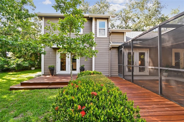 344 Cascade Ln, Palm Harbor, FL 34684 - back of house featuring french doors, a deck, a yard, a lanai, and a shingled roof