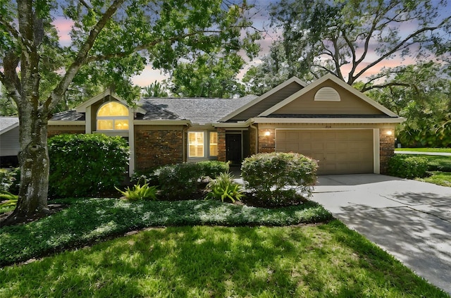 344 Cascade Ln, Palm Harbor, FL 34684 - single story home with an attached garage, concrete driveway, brick siding, roof with shingles, and a lawn