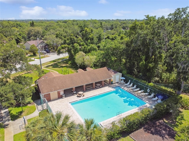 344 Cascade Ln, Palm Harbor, FL 34684 - community pool featuring a wooded view and a patio