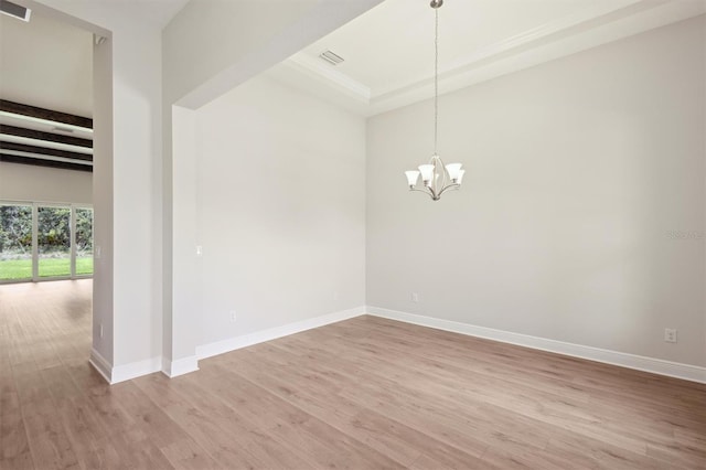 14531 Swiss Bridge Dr, Lithia, FL 33547 - spare room featuring a chandelier, light wood-style floors, a tray ceiling, and beamed ceiling