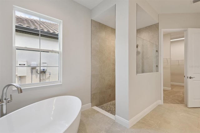 14531 Swiss Bridge Dr, Lithia, FL 33547 - full bathroom with a walk in shower, a freestanding bath, a spacious closet, and plenty of natural light