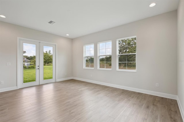 14531 Swiss Bridge Dr, Lithia, FL 33547 - spare room featuring recessed lighting, french doors, and light wood finished floors