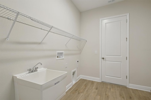 14531 Swiss Bridge Dr, Lithia, FL 33547 - laundry area with hookup for an electric dryer, hookup for a washing machine, and light wood-type flooring