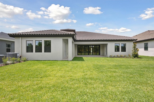 14531 Swiss Bridge Dr, Lithia, FL 33547 - rear view of property with stucco siding, a tile roof, and a yard