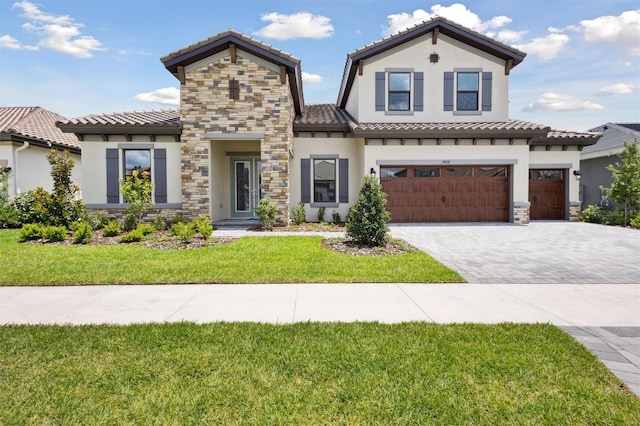 14531 Swiss Bridge Dr, Lithia, FL 33547 - mediterranean / spanish-style home featuring stone siding, a tiled roof, and stucco siding