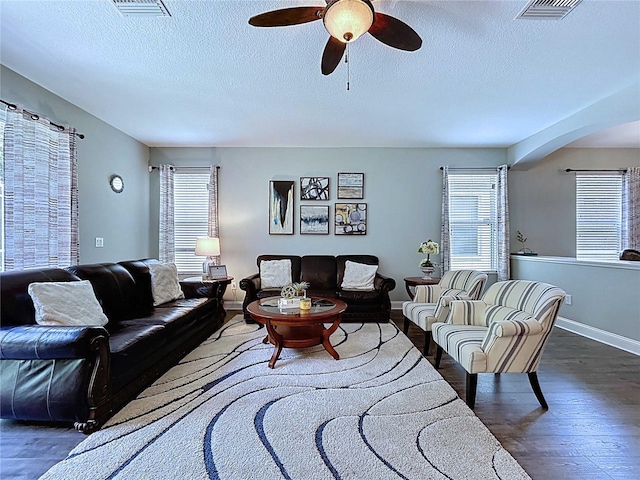 4116 Knollpoint Dr, Wesley Chapel, FL 33544 - living area featuring wood finished floors, a ceiling fan, arched walkways, and a textured ceiling