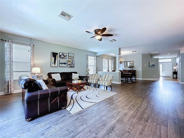4116 Knollpoint Dr, Wesley Chapel, FL 33544 - living room featuring wood finished floors, ceiling fan, arched walkways, a textured ceiling, and a chandelier