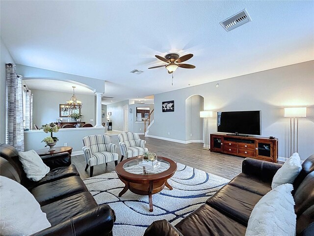 4116 Knollpoint Dr, Wesley Chapel, FL 33544 - living area featuring arched walkways, ornate columns, ceiling fan, and wood finished floors