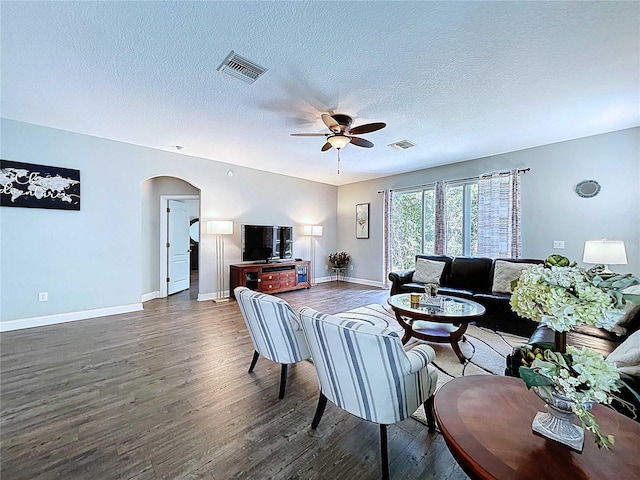 4116 Knollpoint Dr, Wesley Chapel, FL 33544 - living room with arched walkways, wood finished floors, a ceiling fan, and a textured ceiling