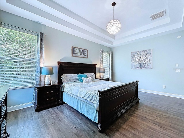 4116 Knollpoint Dr, Wesley Chapel, FL 33544 - bedroom with multiple windows, a chandelier, wood finished floors, and a raised ceiling