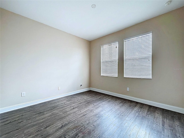 4116 Knollpoint Dr, Wesley Chapel, FL 33544 - empty room featuring dark wood-type flooring and a smoke detector