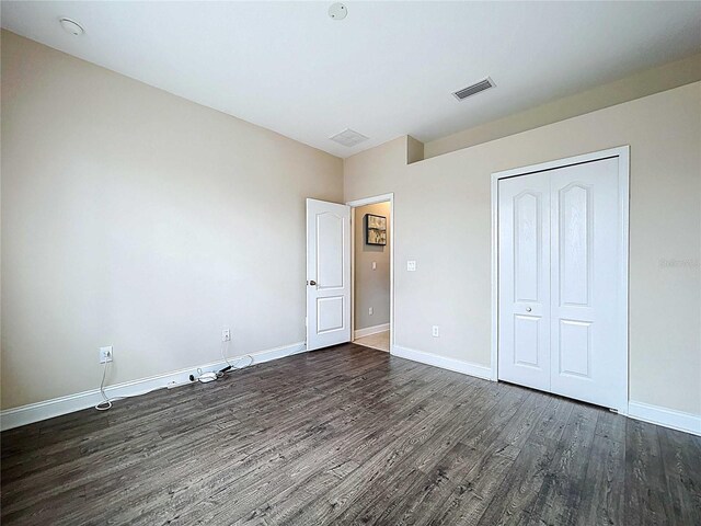 4116 Knollpoint Dr, Wesley Chapel, FL 33544 - unfurnished bedroom featuring dark wood-style flooring and a closet