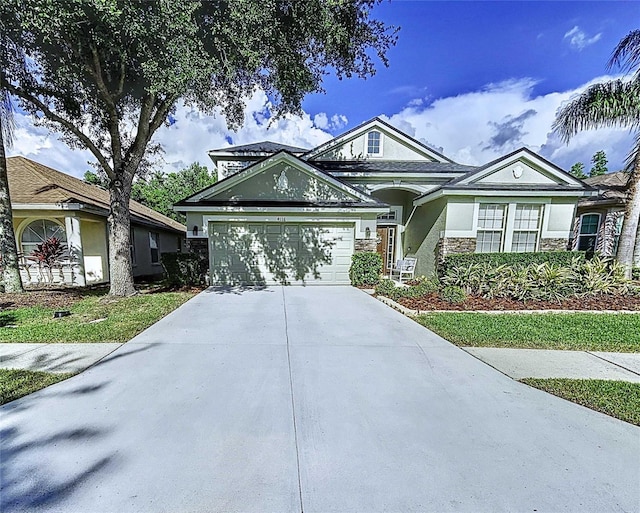 4116 Knollpoint Dr, Wesley Chapel, FL 33544 - view of front of house featuring stucco siding, concrete driveway, stone siding, and a garage