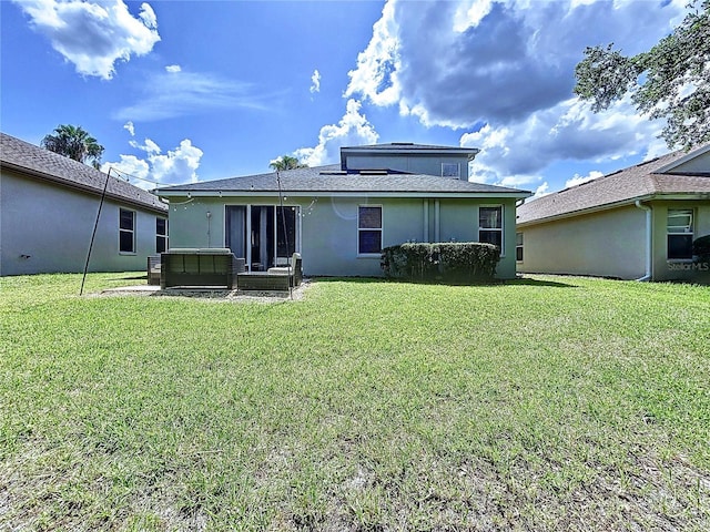 4116 Knollpoint Dr, Wesley Chapel, FL 33544 - back of property featuring a jacuzzi, a lawn, and stucco siding