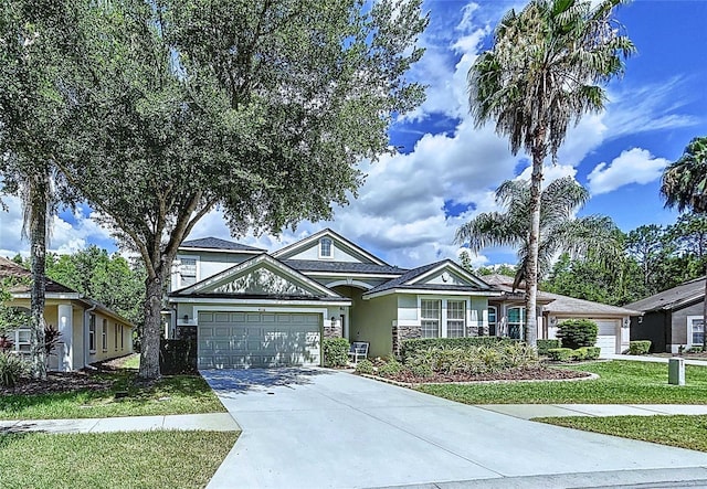 4116 Knollpoint Dr, Wesley Chapel, FL 33544 - view of front of property with stucco siding, an attached garage, concrete driveway, and a front lawn