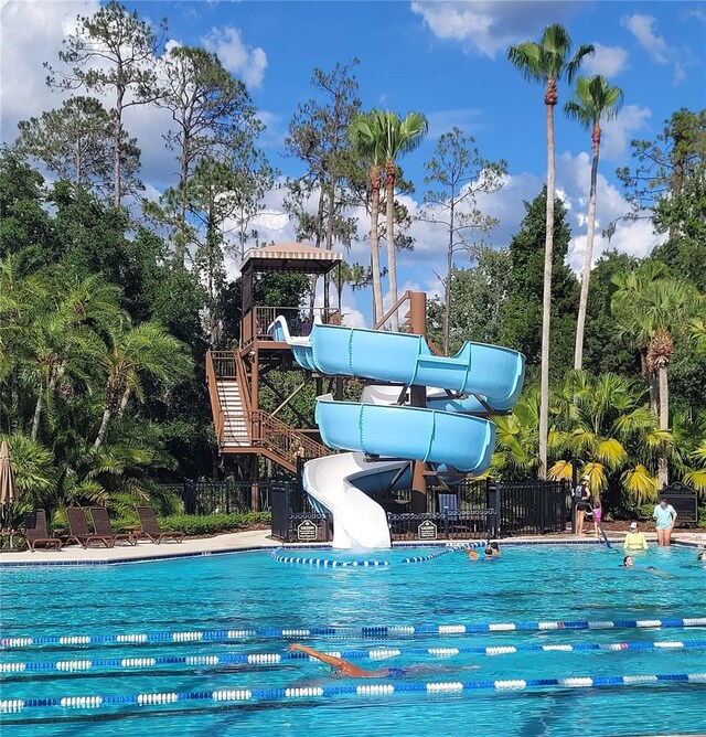 4116 Knollpoint Dr, Wesley Chapel, FL 33544 - community pool with a water slide and view of wooded area