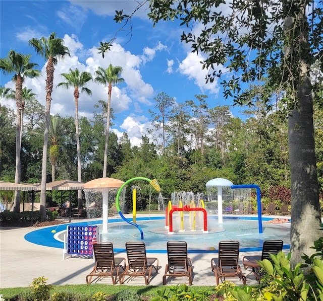 4116 Knollpoint Dr, Wesley Chapel, FL 33544 - community pool featuring a water play area and view of wooded area