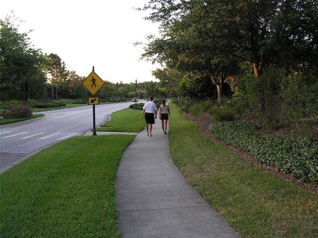 4116 Knollpoint Dr, Wesley Chapel, FL 33544 - view of asphalt road featuring traffic signs and sidewalks