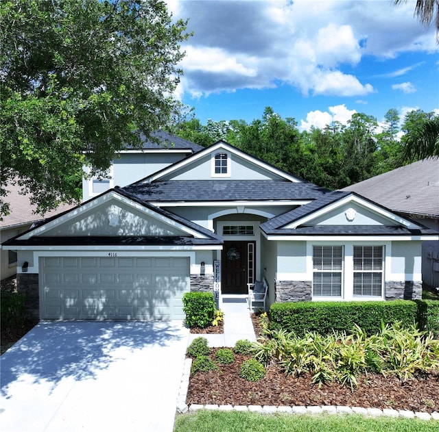 4116 Knollpoint Dr, Wesley Chapel, FL 33544 - ranch-style home featuring stone siding, a garage, concrete driveway, stucco siding, and a shingled roof