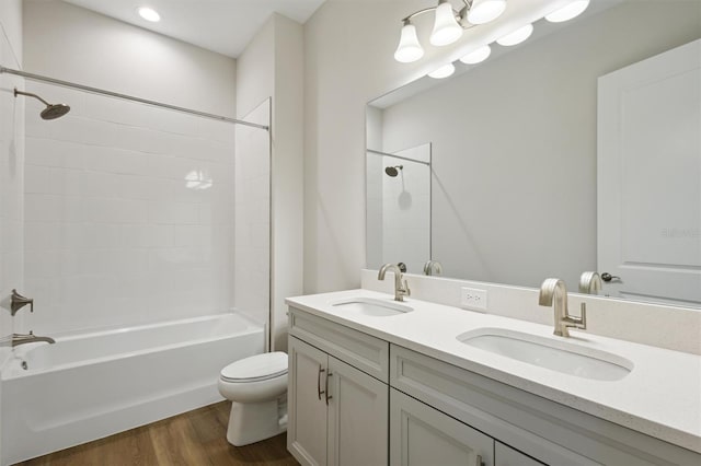14523 Swiss Bridge Dr, Lithia, FL 33547 - full bathroom featuring double vanity,  shower combination, and wood finished floors