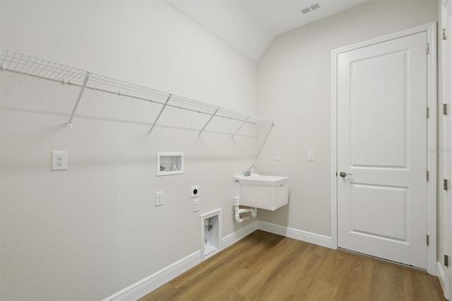 14523 Swiss Bridge Dr, Lithia, FL 33547 - laundry room featuring hookup for an electric dryer, washer hookup, and light wood-style flooring