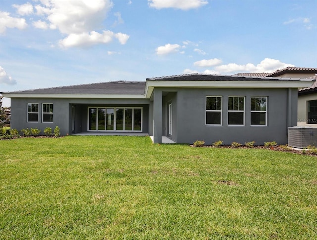 14523 Swiss Bridge Dr, Lithia, FL 33547 - rear view of house featuring stucco siding and a lawn