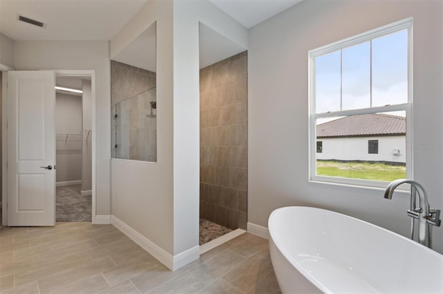 14523 Swiss Bridge Dr, Lithia, FL 33547 - full bath featuring a walk in shower, a freestanding bath, and a spacious closet