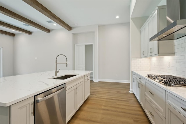 14523 Swiss Bridge Dr, Lithia, FL 33547 - kitchen featuring appliances with stainless steel finishes, wall chimney range hood, light wood finished floors, tasteful backsplash, and light stone countertops