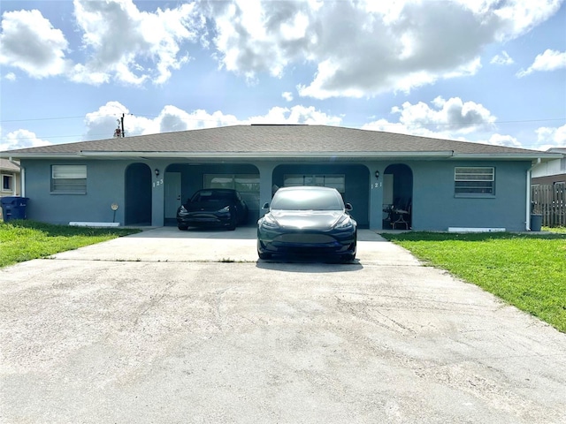 121 Granada Blvd, North Port, FL 34287 - ranch-style home with driveway, stucco siding, a front lawn, and an attached garage