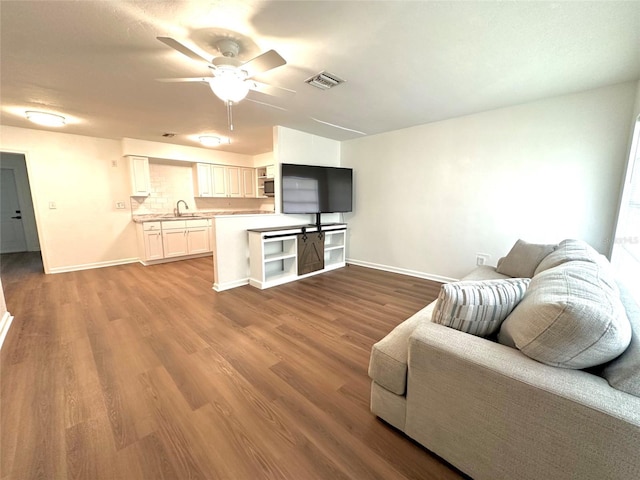 121 Granada Blvd, North Port, FL 34287 - living area featuring a ceiling fan and wood finished floors