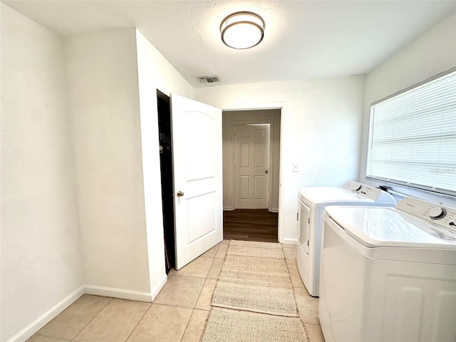 121 Granada Blvd, North Port, FL 34287 - washroom featuring washing machine and clothes dryer and light tile patterned floors