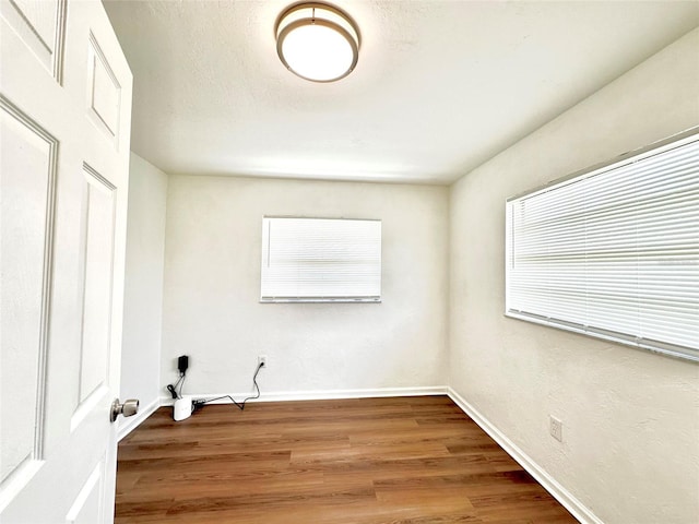 121 Granada Blvd, North Port, FL 34287 - empty room with healthy amount of natural light and wood finished floors