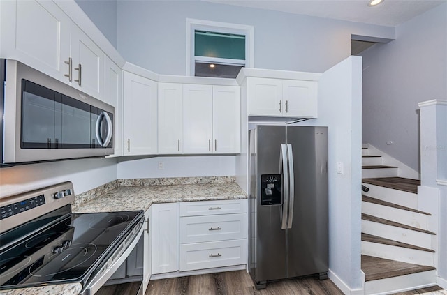 6206 92nd Pl N Unit 3605, Pinellas Park, FL 33782 - kitchen with stainless steel appliances, dark wood finished floors, white cabinetry, and light stone countertops