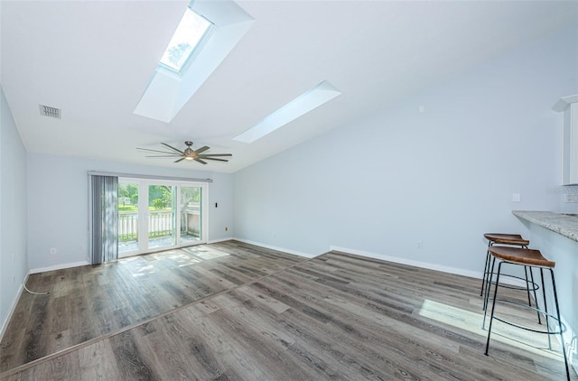 6206 92nd Pl N Unit 3605, Pinellas Park, FL 33782 - unfurnished living room with a skylight, wood finished floors, and lofted ceiling